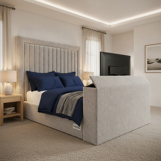 Modern bedroom with a gray upholstered bed and television.