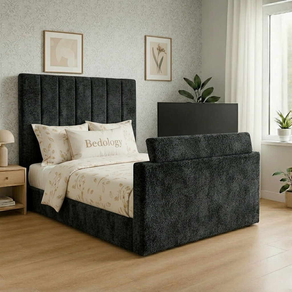 Gray upholstered bed with green bedding in a bedroom setting.